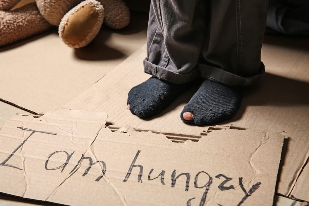 child's feet on a message about hunger